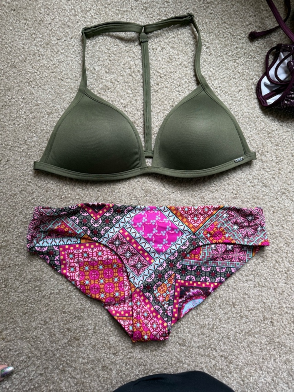 Patchwork pink bikini bottoms and a padded olive green halter top.